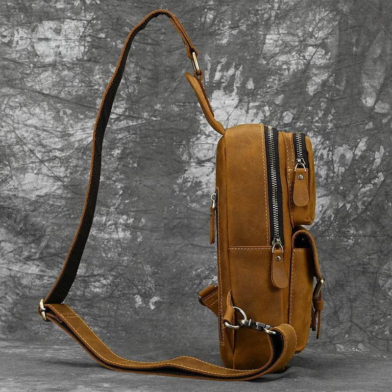 Mens vintage travel chest bag in brown leather with adjustable strap and multiple compartments