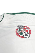 White Men's Tee featuring World Cup Mexico team shirt logo and green accents for soccer fans
