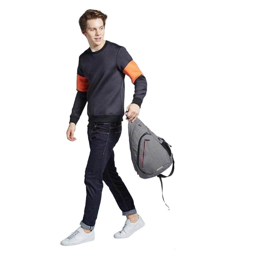 Gray USB charging crossbody backpack with adjustable straps for convenient travel and daily use