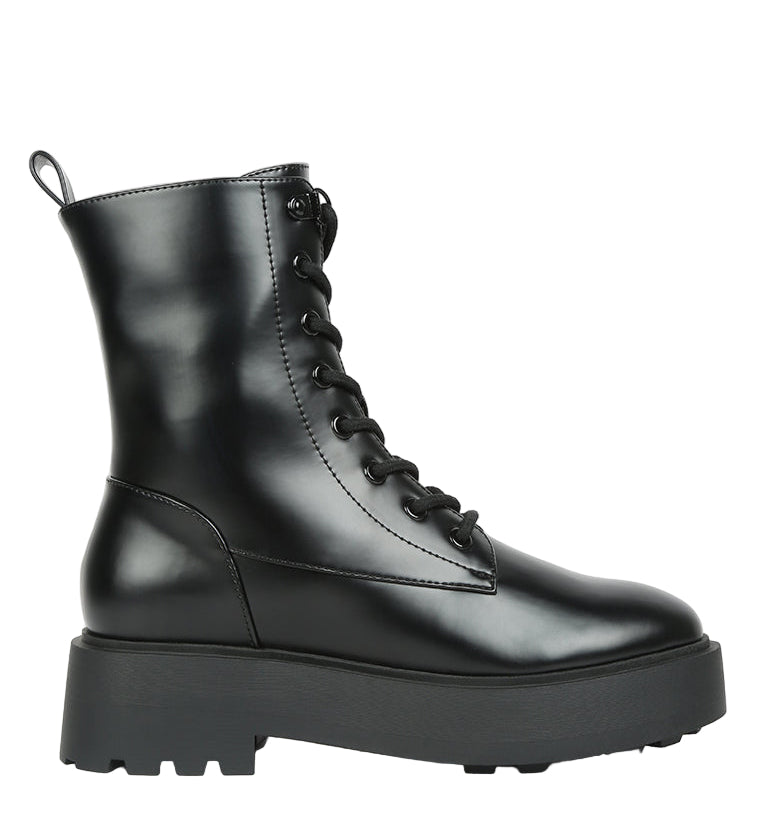 Black leather boot with a platform sole on a white background