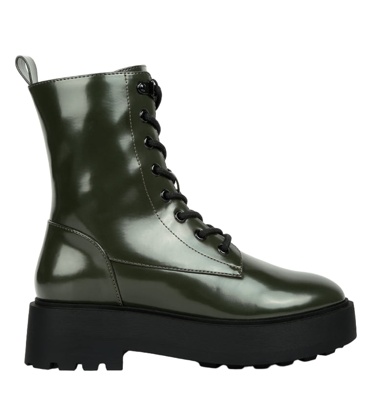 Green leather boot with a platform sole on a white background