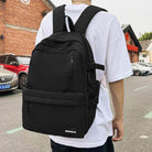 Sleek black nylon backpack for travel with multiple compartments and padded straps for comfort