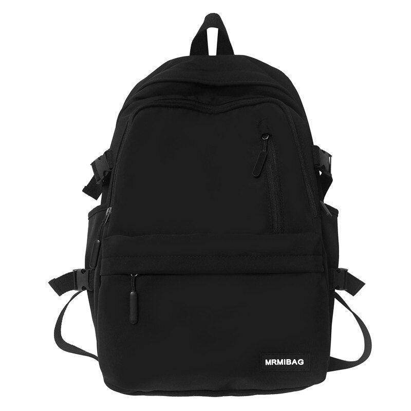 Sleek black nylon backpack for travel with multiple pockets and adjustable straps