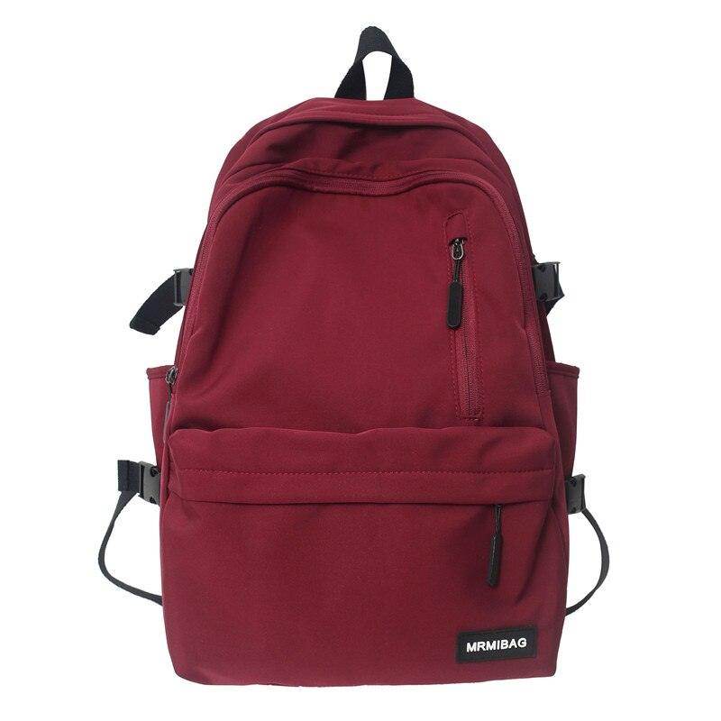Maroon nylon backpack for travel with multiple pockets and adjustable straps