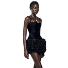 Woman wearing black nightclub bandage dress for women with floral details and textured skirt