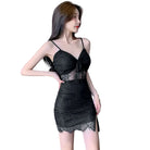 Woman wearing a black nightclub coquette slip dress with lace details and spaghetti straps