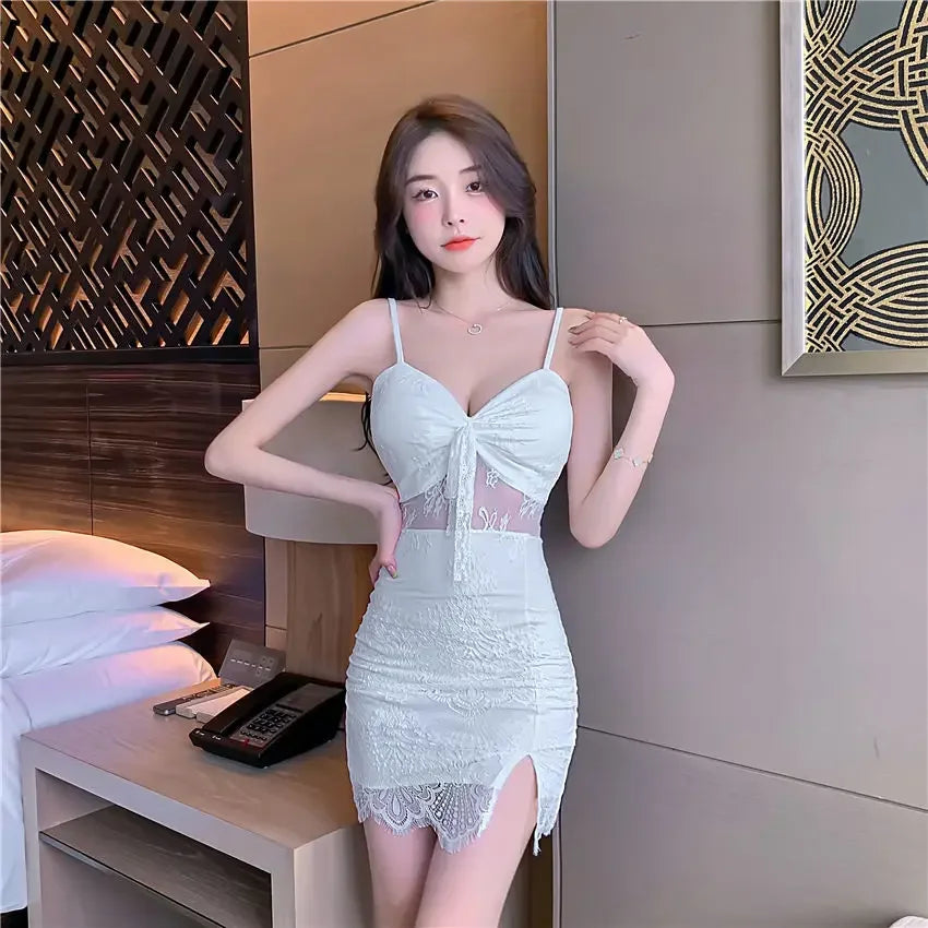 Model wearing white nightclub coquette slip dress with lace details and spaghetti straps indoors