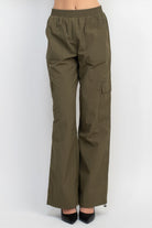 Women's olive green high-rise cargo parachute pants with elastic waistband and side pockets