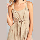 Ivory Felix one-piece romper with open back featuring a stylish tie front design and soft fabric