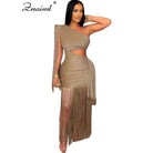 Elegant woman wearing a gold one shoulder fringe dress with long fringe detailing and cutout waist