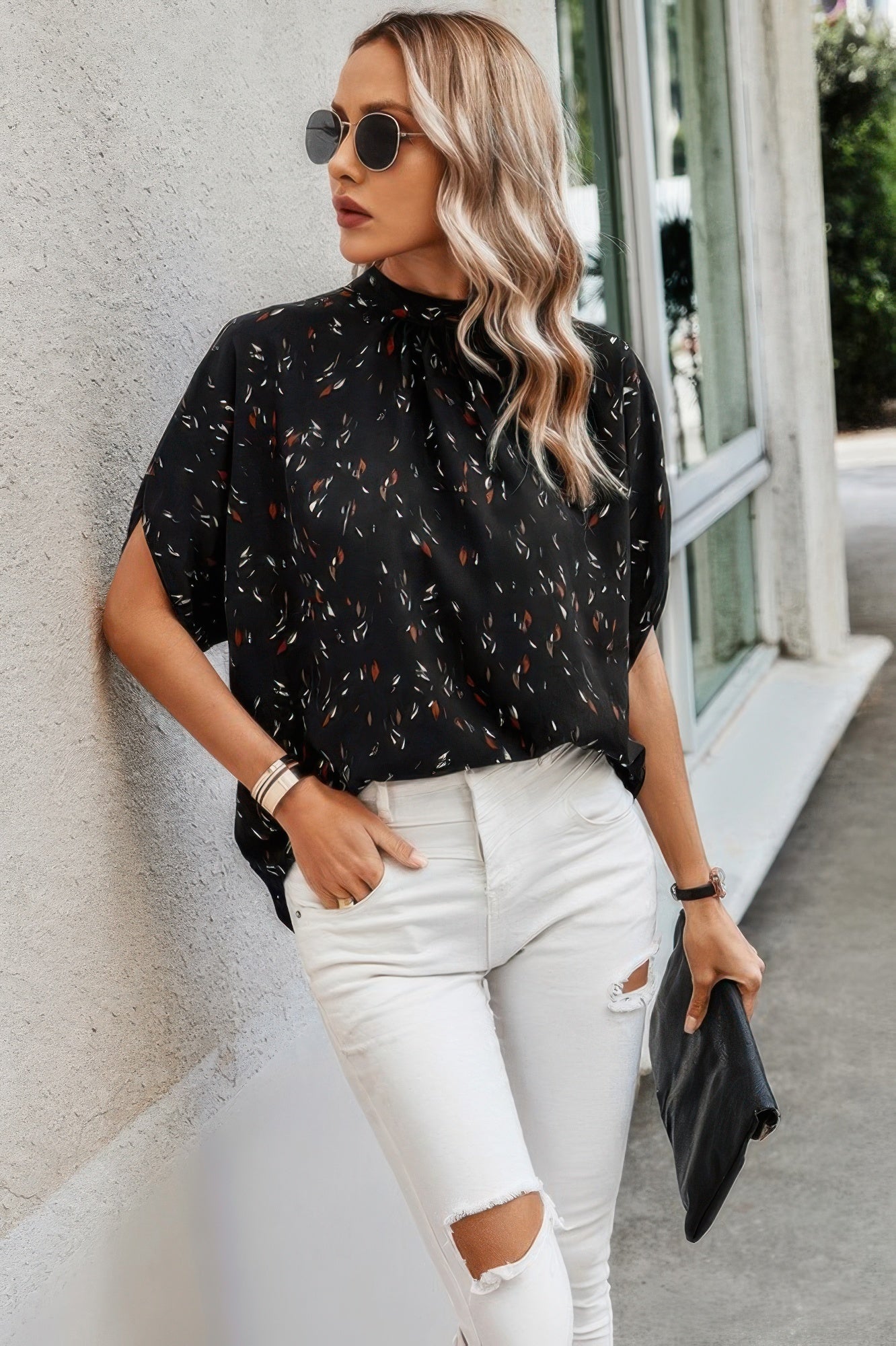 Stylish black open back summer tops for women with colorful patterns paired with white ripped jeans