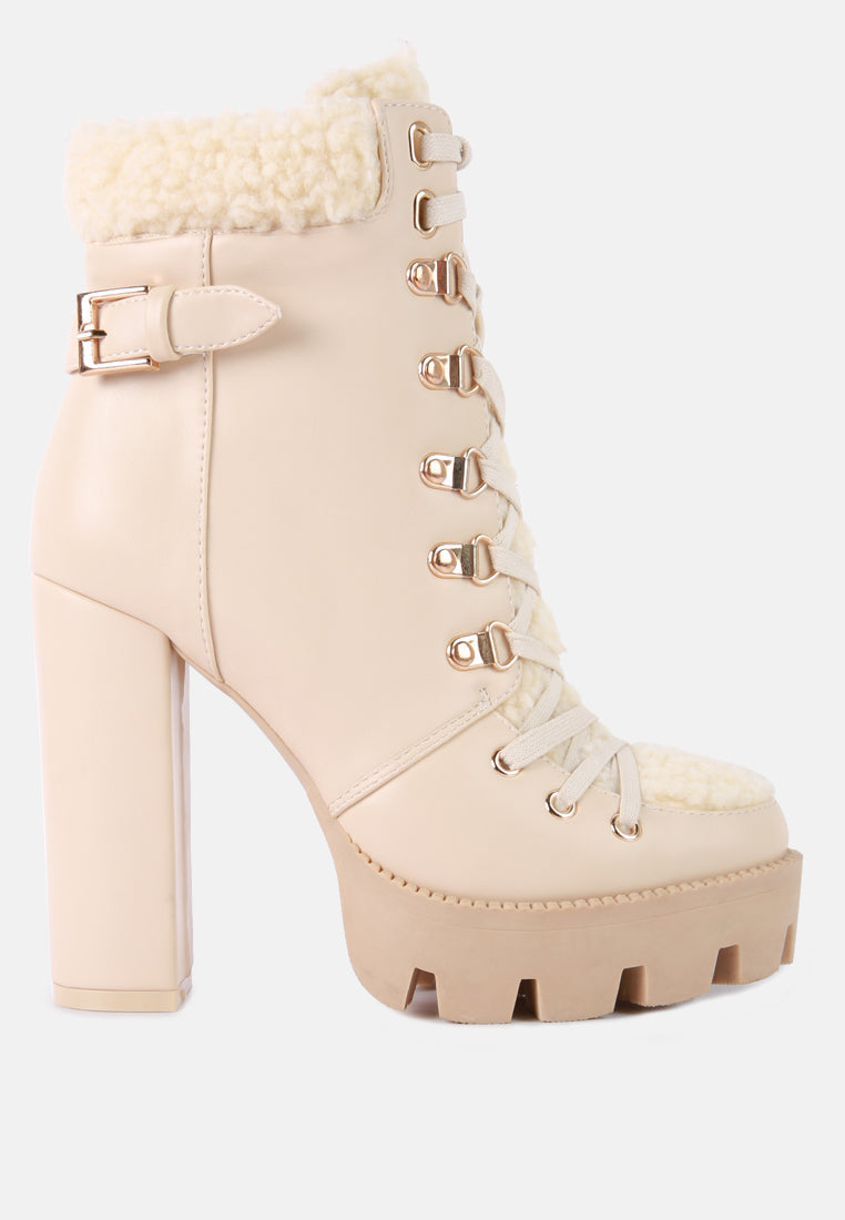Beige platform boot with lace-up design and chunky heel on a white background