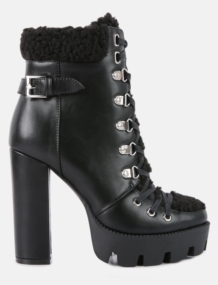 Black platform boot with high heel and lace-up design on a white background