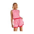 Woman wearing Miss Sparkling casual matching shorts and top set in pink with red trim details