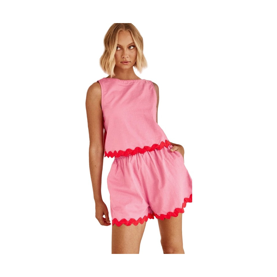 Woman wearing Miss Sparkling casual matching shorts and top set in pink with red trim details