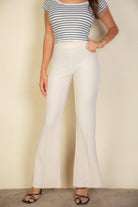 VacationGrabs pink flare trousers for women styled with a striped top and black heels