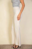 VacationGrabs white women's pants styled with a striped top and black heels, perfect alternative to pink flare trousers for women