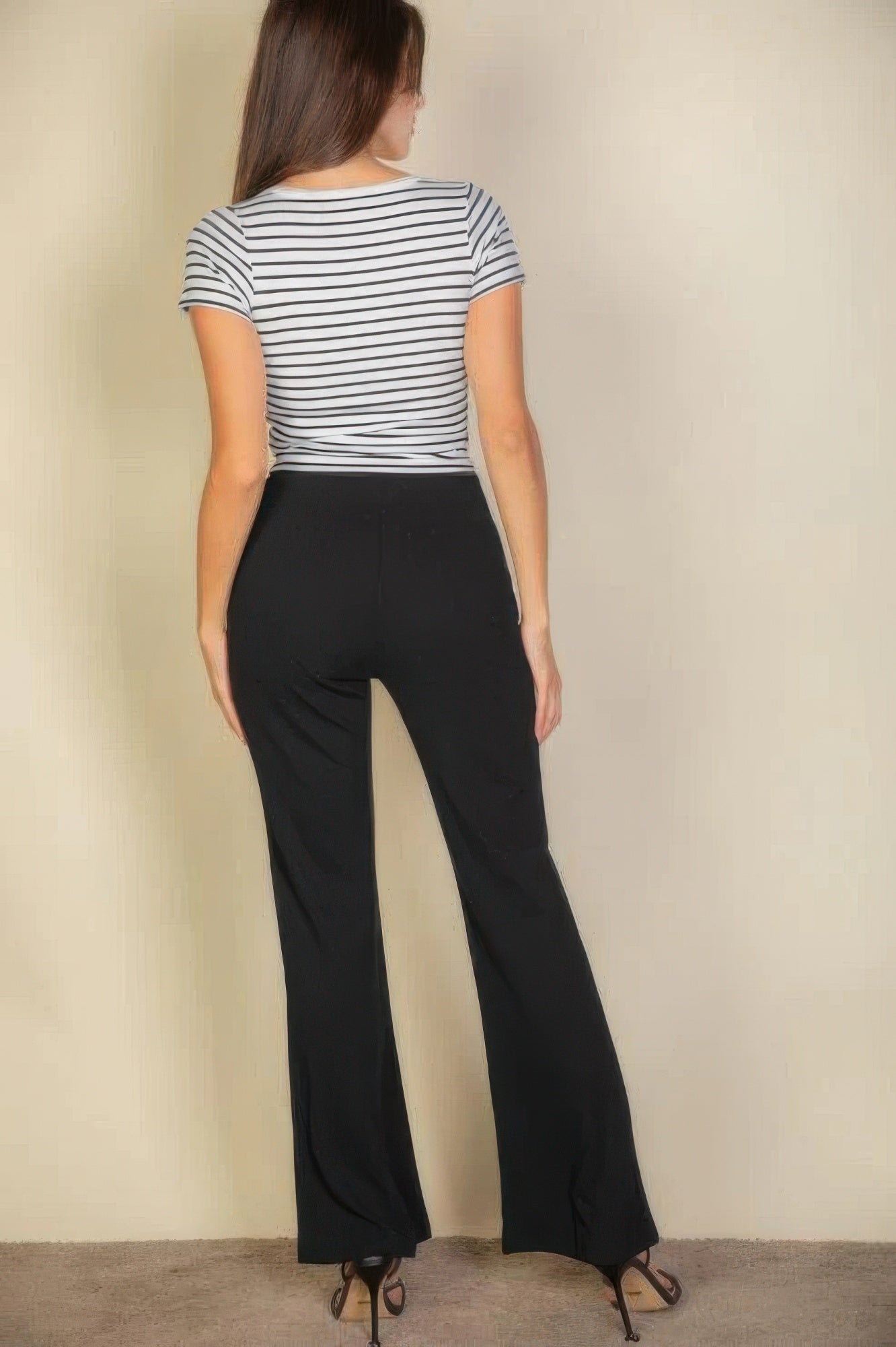 VacationGrabs black flare pants for women shown from back with striped top and heels