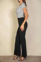 VacationGrabs women's black flare pants styled with a striped top and heels, replace pink flare trousers for women