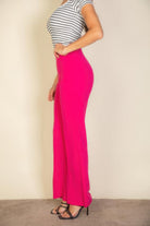 VacationGrabs pink flare trousers for women paired with striped fitted top and black heels