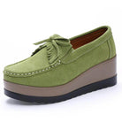 Green VacatoinGrabs platform slip-ons for travel with a comfortable wedge design and stylish bow detail