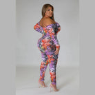 Plus size snake print jumpsuit with vibrant colors and off-shoulder design by VacationGrabs