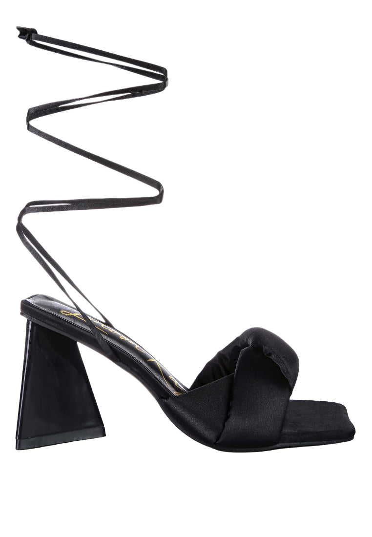 Black high-heeled sandal with a unique heel design on a white background