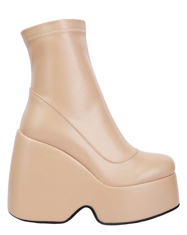 Beige platform ankle boot on a white background