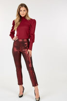 VacationGrabs women's ankle length faux leather pants in metallic burgundy styled with a red puff sleeve top