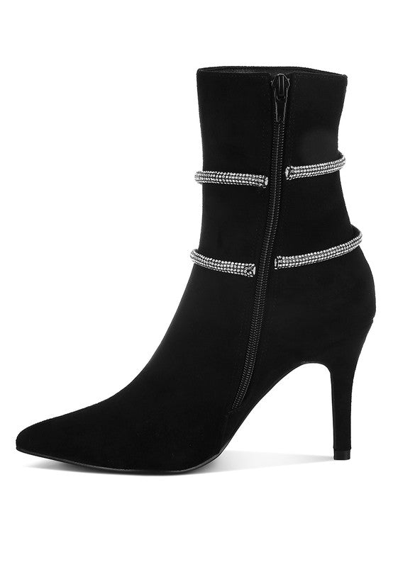 Stylish black ankle boots with zip and decorative straps, perfect for pairing with outfits and enhancing style.