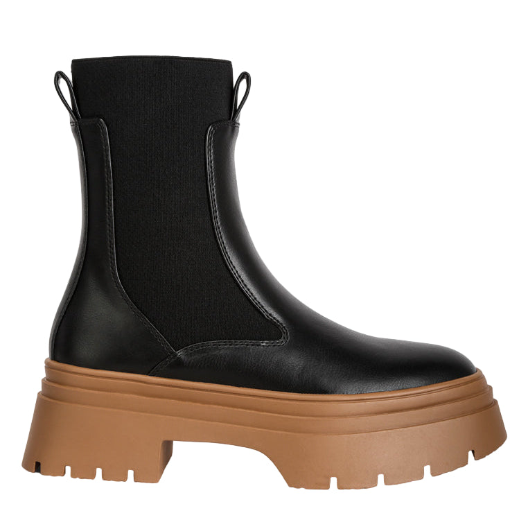 Black platform boot with brown sole on a white background