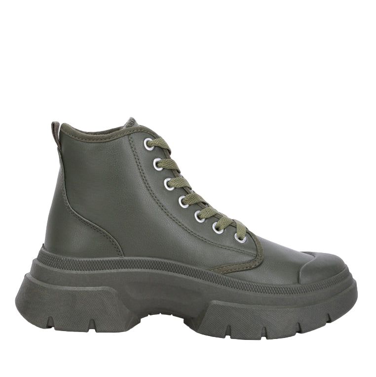 Green boot with a thick sole on a white background