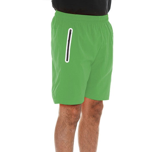 WEIV men's running shorts with zip pocket in green worn with white sneakers