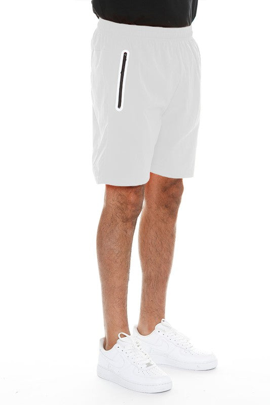 Men's WEIV running shorts with zip pocket in white modeled with white sneakers