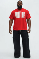 Ruthless ambition t-shirt for men in red with bold white ambition text modeled with black cargo pants