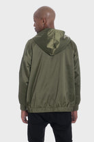 Back view of a person wearing olive green satin hooded windbreaker jacket by WEIV