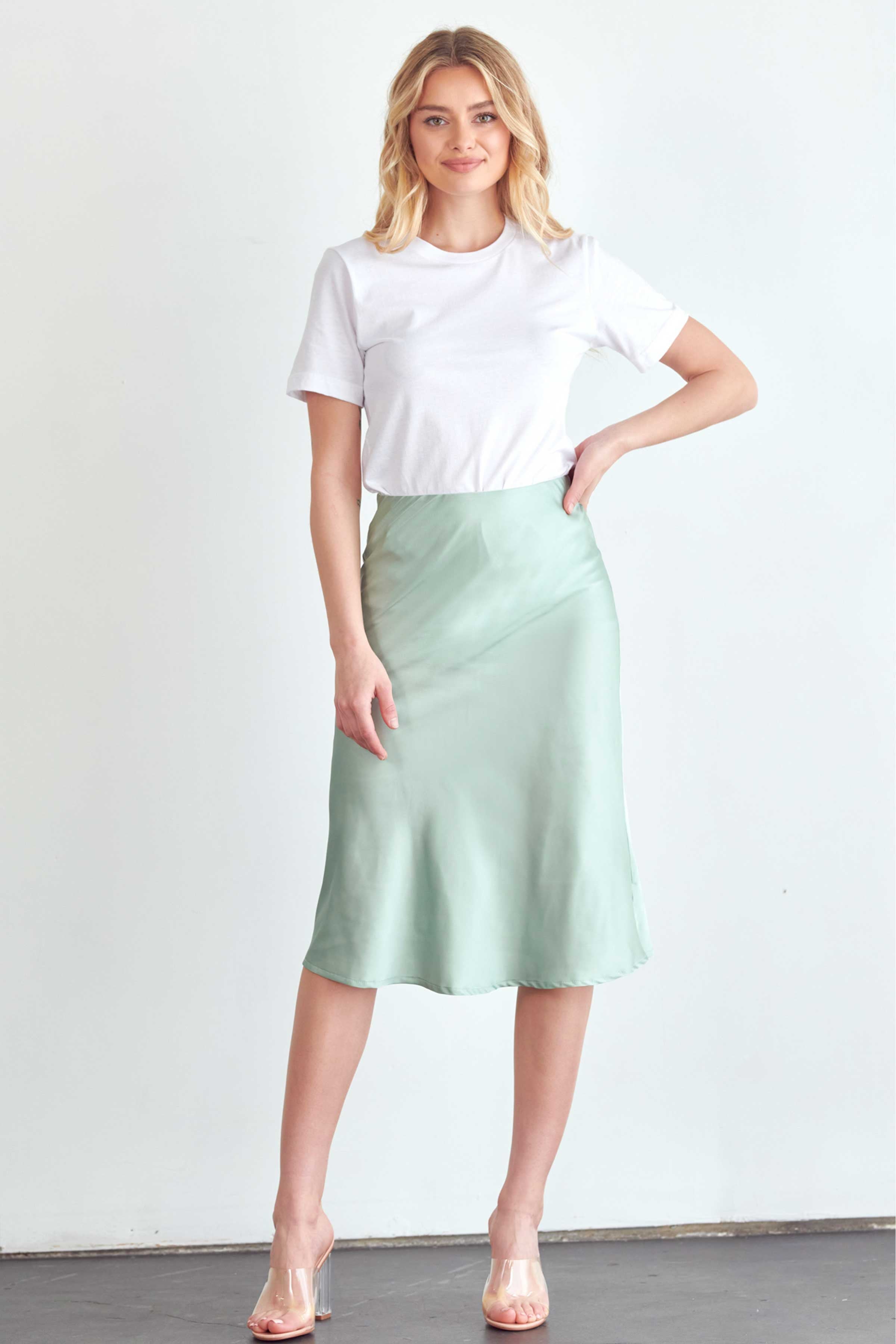 BLUME AND CO. satin midi skirt for women in light green styled with white t-shirt and clear heels