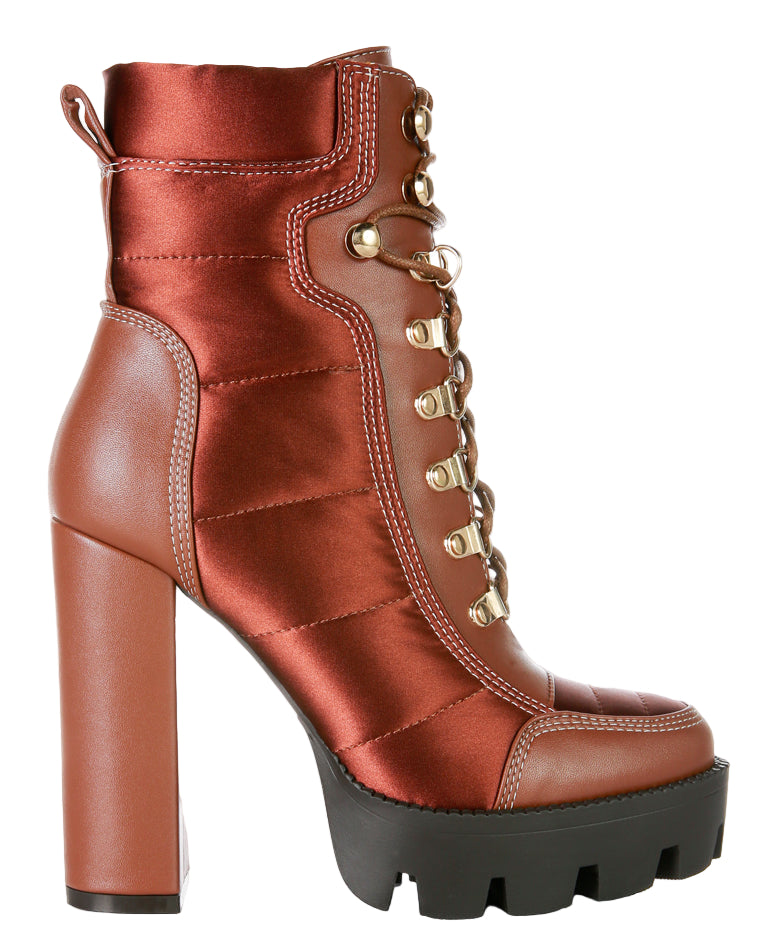 Brown platform boot with gold laces on a white background