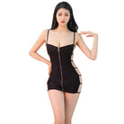Young woman wearing a sexy bandage mini dress in black with zipper front and cutout sides