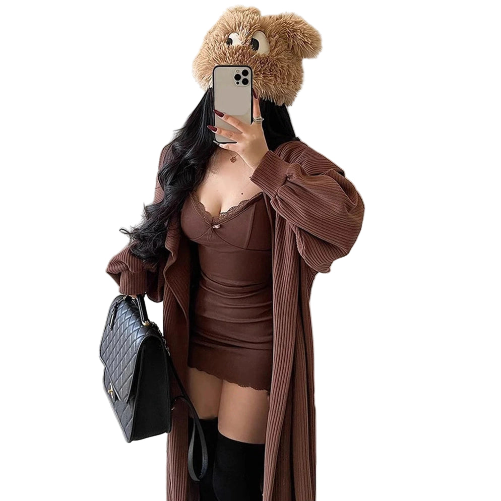 Woman wearing a sexy black club dress for women with a brown oversized cardigan and black handbag