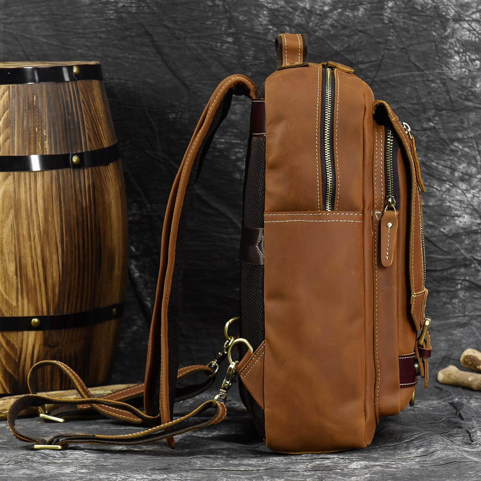Brown leather shoulder backpack for travel with multiple pockets and adjustable straps