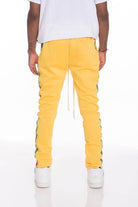 Men's yellow side taped track pants by WEIV with a trendy slim fit and stylish side design