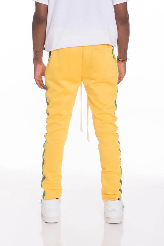 Men's yellow side taped track pants by WEIV with a trendy slim fit and stylish side design