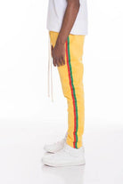 WEIV men's joggers featuring side taped track pants in yellow with red and green stripes