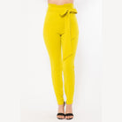 VacationGrabs women's yellow skinny pants with belt accent in a high waist design
