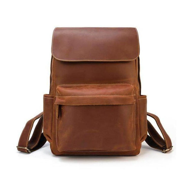 Brown soft leather backpacks for travel featuring a spacious exterior pocket and adjustable straps