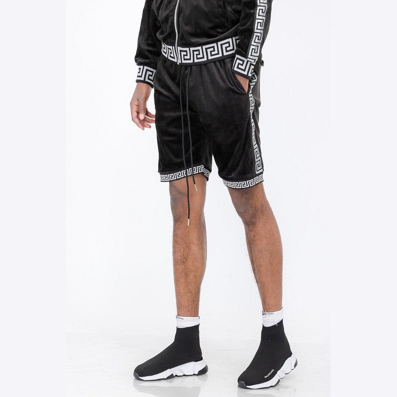 Black soft velour athletic shorts with white geometric trim worn with matching jacket and black sneakers