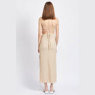 Back view of Emory Park spaghetti strap midi dress in beige with a tied open back design