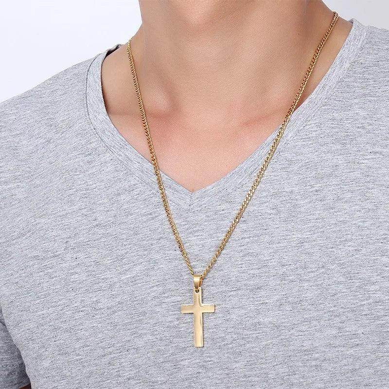 VacationGrabs stainless steel cross necklace on a man wearing a gray v-neck shirt, showcasing modern style