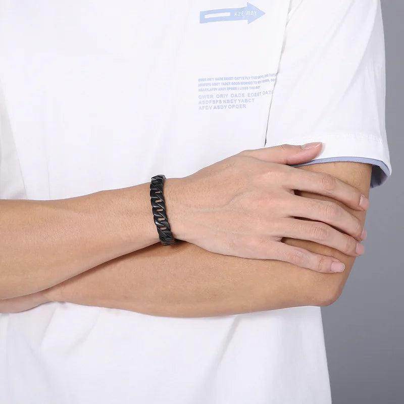 Men's stainless steel Cuban chain bracelet worn on wrist for a stylish look